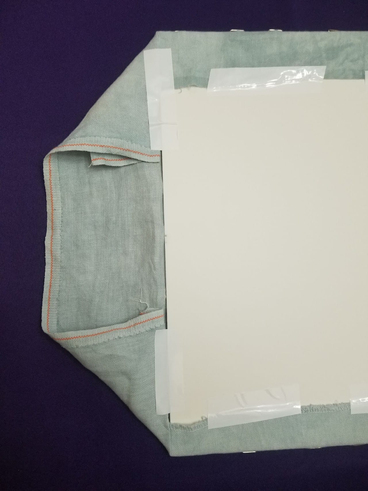 Wrapping fabric around the foam core and taping it down