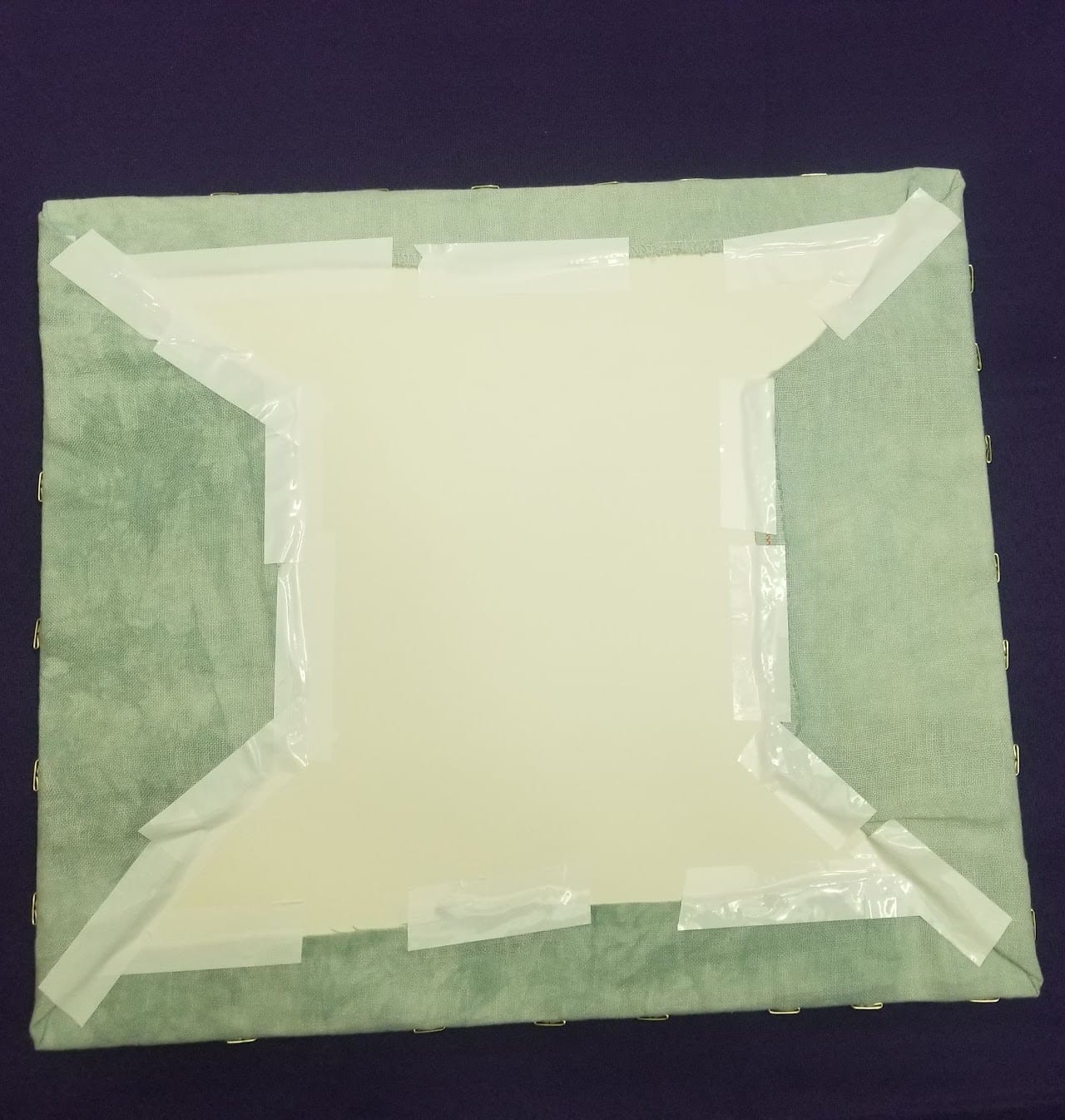 The back of the piece, fully taped with neat folded corners
