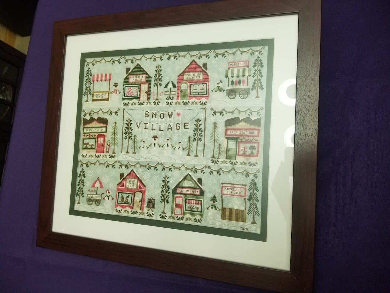 The finished framed cross stitch piece