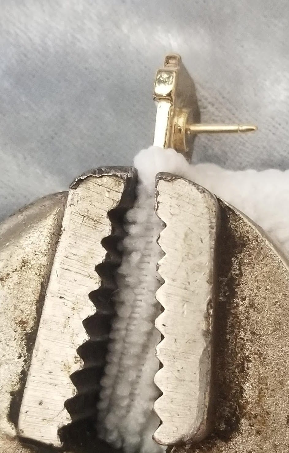 Pin wrapped in a towel and clamped in the vice grip