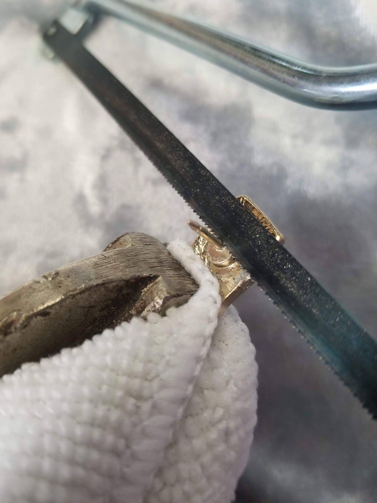 Sawing the pin back off with a metal hand saw