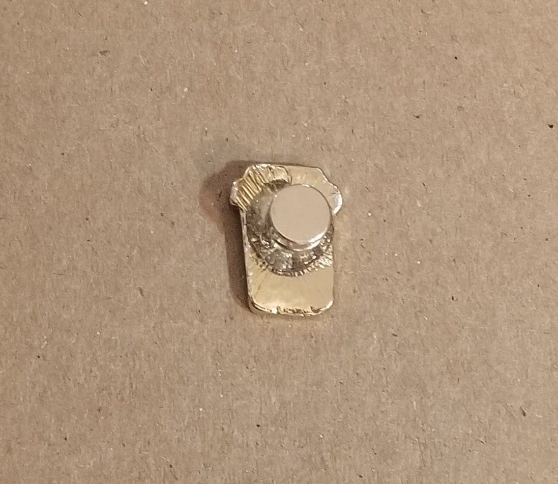 Applying E6000 adhesive to the back of the pin