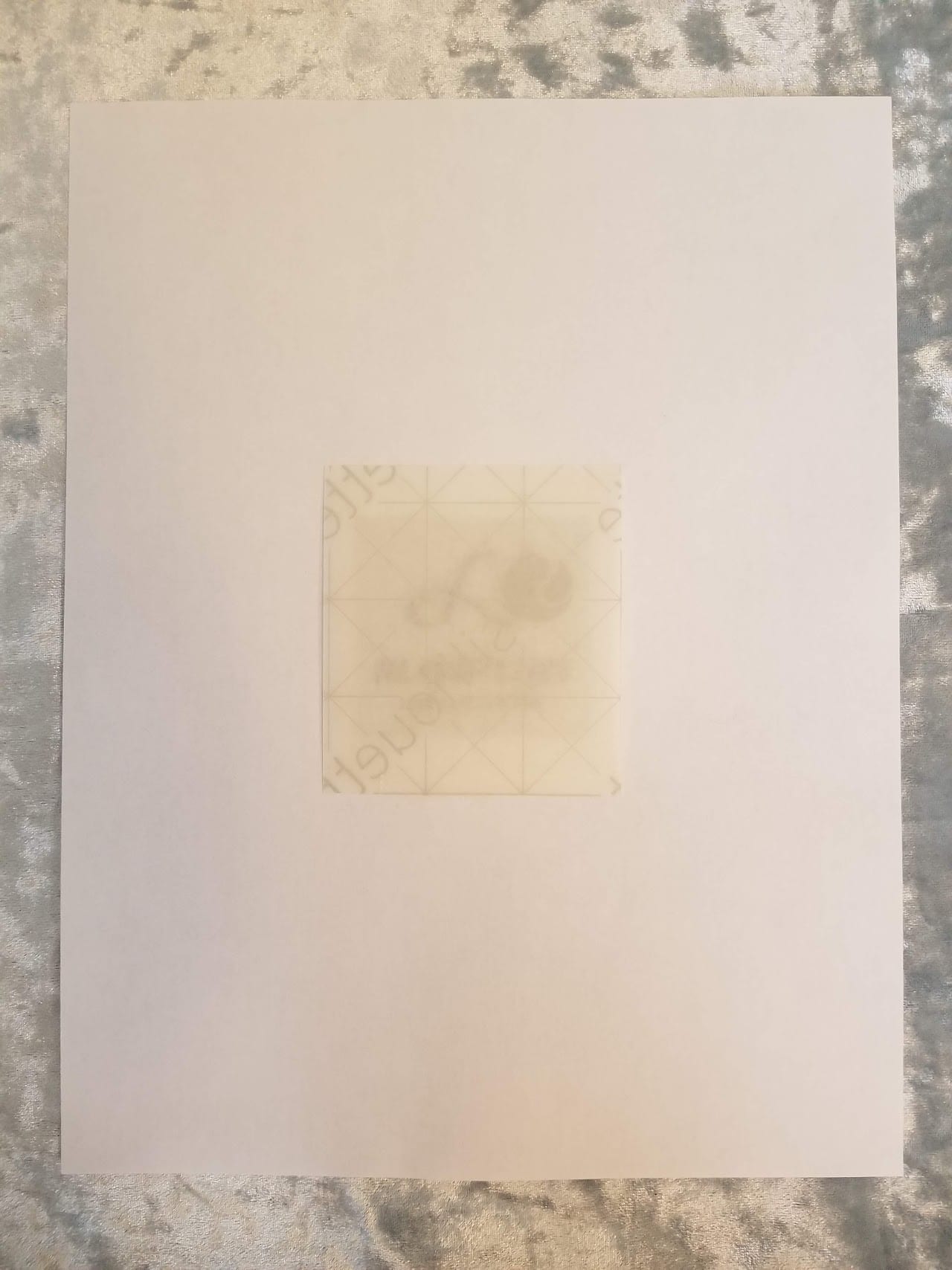 Shrink plastic taped over the printed image