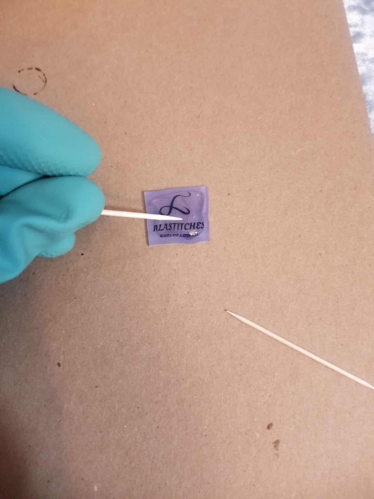 Spreading the UV resin evenly across the piece with a toothpick