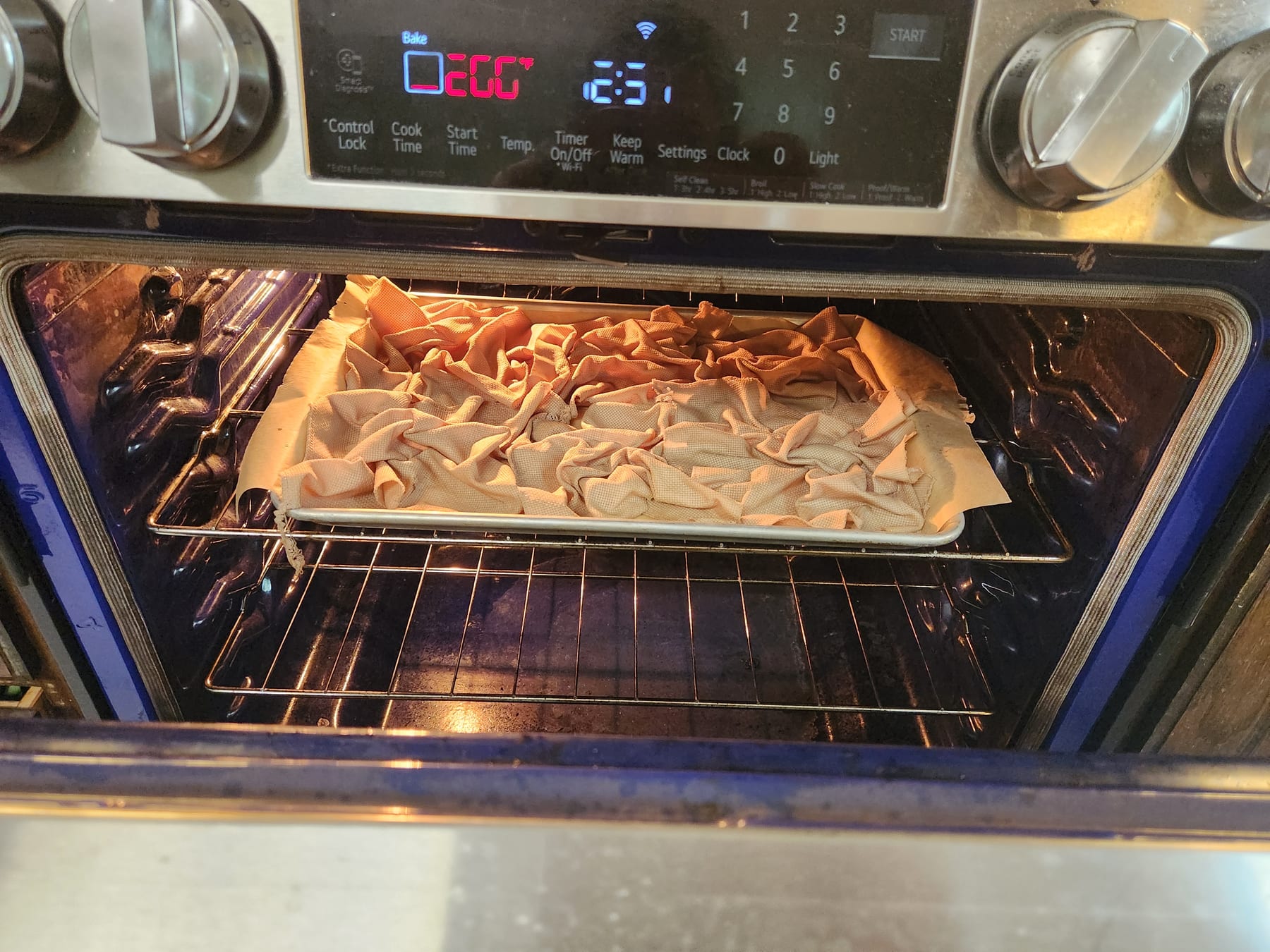 Baking sheet of scrunched dyed fabric inside the oven